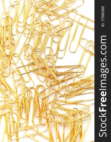 Gleaming golden paperclip isolated on white background