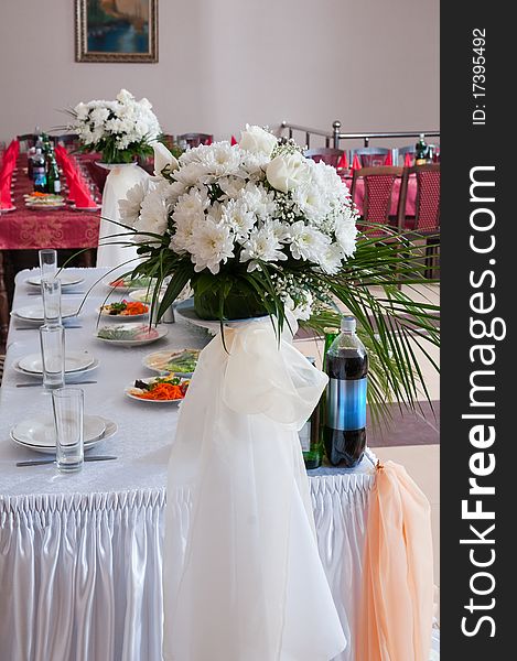 The big white bouquet decorates a restaurant interior. The big white bouquet decorates a restaurant interior.