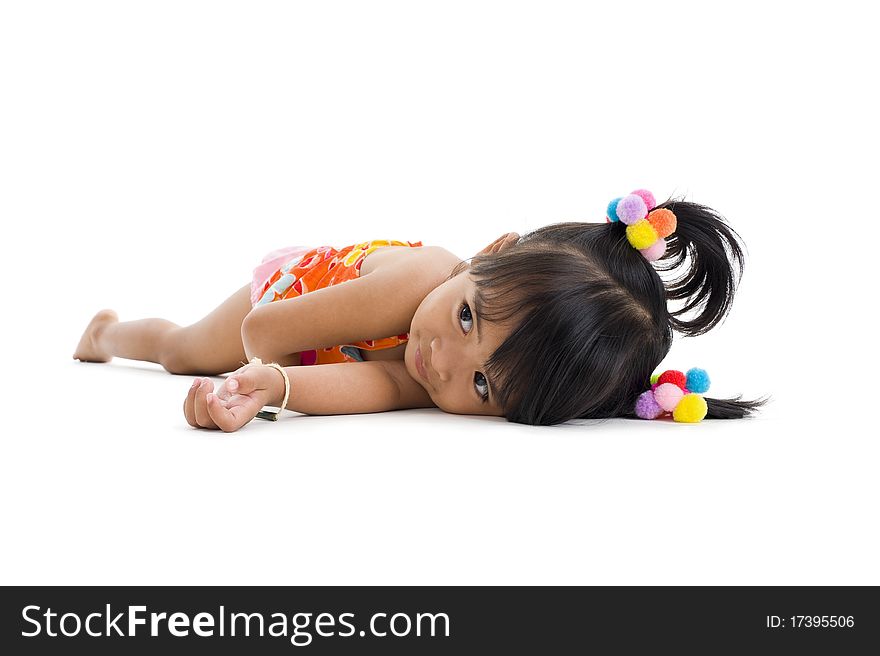 Cute little girl laying down, isolated on white background