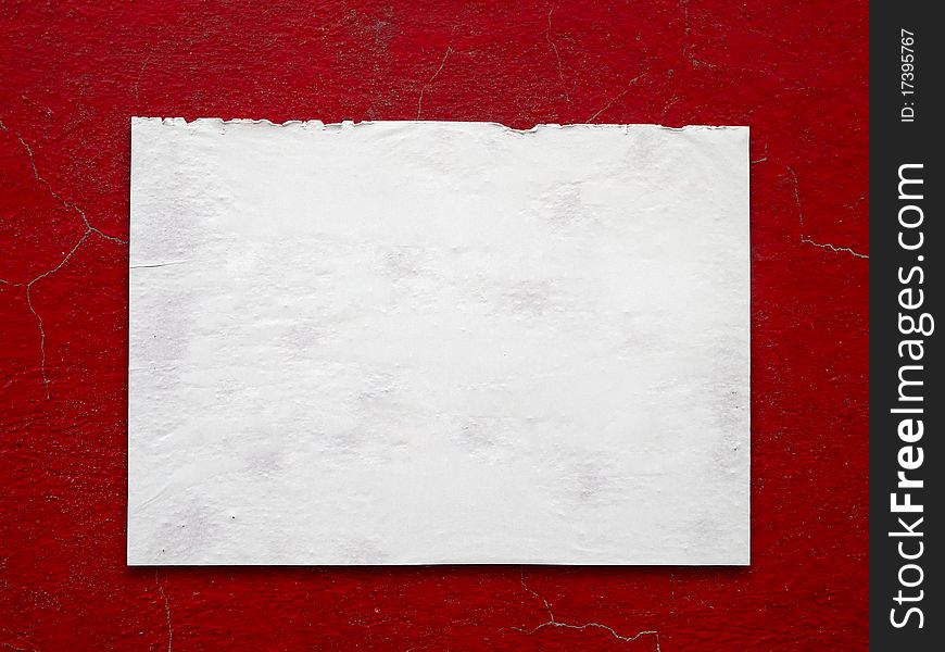 Texture of white paper stick on crack old red wall