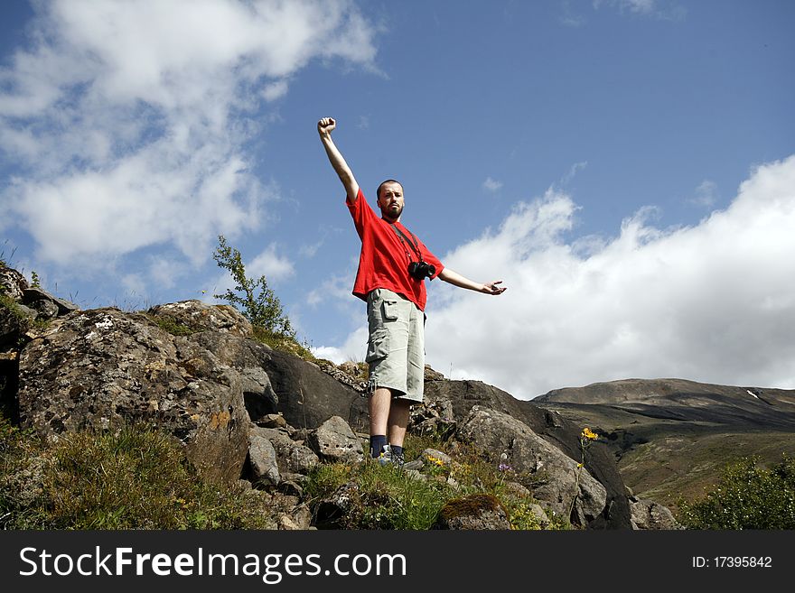 Young male traveller, photographer enjoying the beautiful view of mountains in Iceland