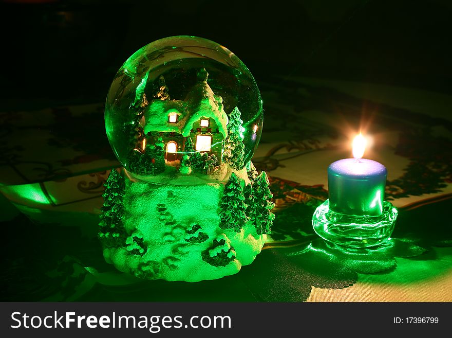 These are Christmas crystal ball and candle, illuminated by green laser. These are Christmas crystal ball and candle, illuminated by green laser.