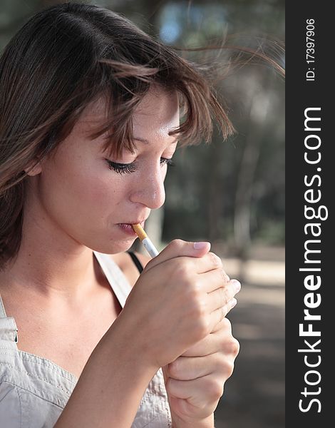 Portrait Of  Young Woman Lighting A Cigarette