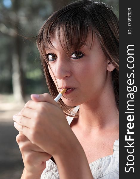 Portrait Of  Young Woman Lighting A Cigarette