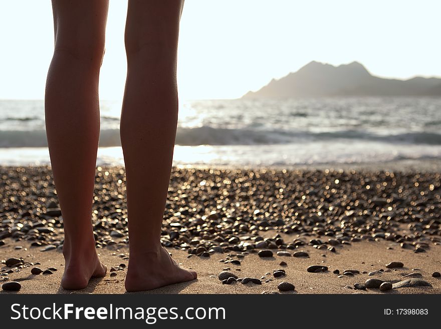 Beautiful young woman on the beach - legs