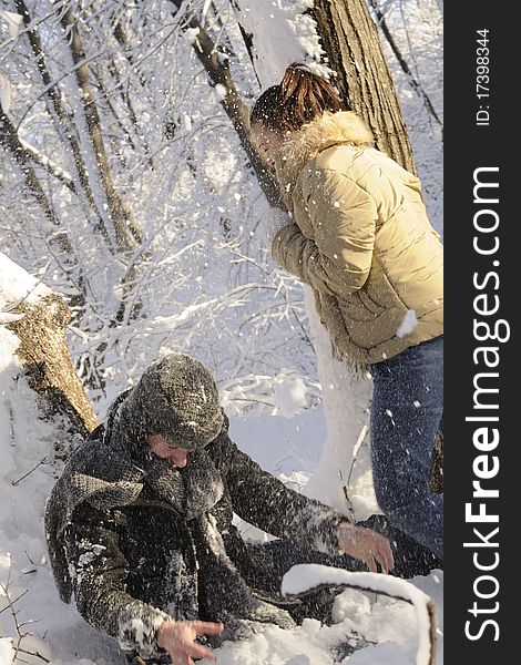 Young man and woman playing with snow in forest, winter season. Young man and woman playing with snow in forest, winter season