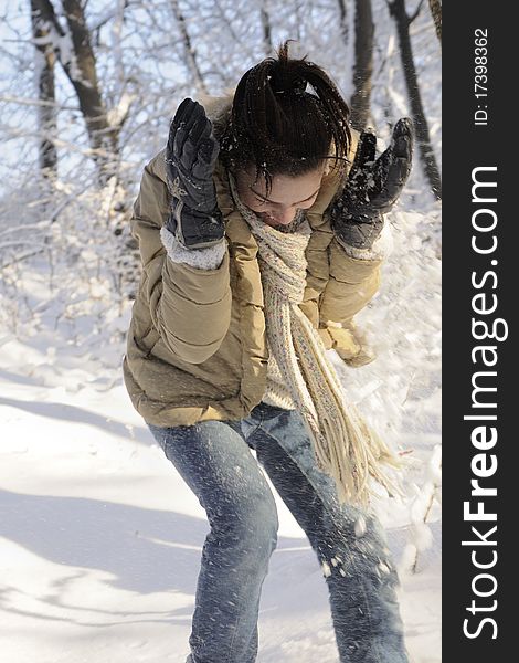 Young woman playing with snow in forest, winter season. Young woman playing with snow in forest, winter season