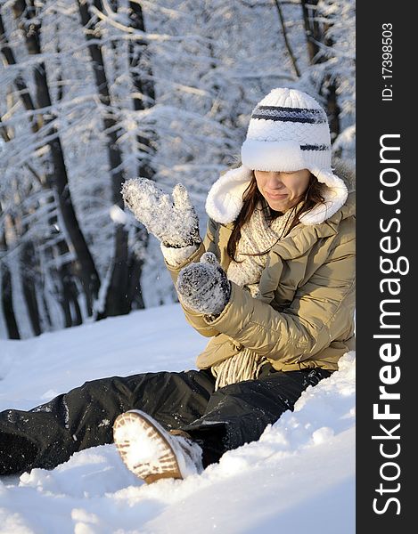 Young woman playing with snow in forest, winter season. Young woman playing with snow in forest, winter season