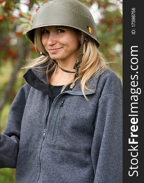 Portrai of beautiful smiling young girl in a helmet with mountain ash in fall park. Portrai of beautiful smiling young girl in a helmet with mountain ash in fall park