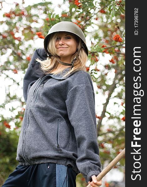 Portrai of beautiful smiling young girl in a helmet with mountain ash in fall park. Portrai of beautiful smiling young girl in a helmet with mountain ash in fall park