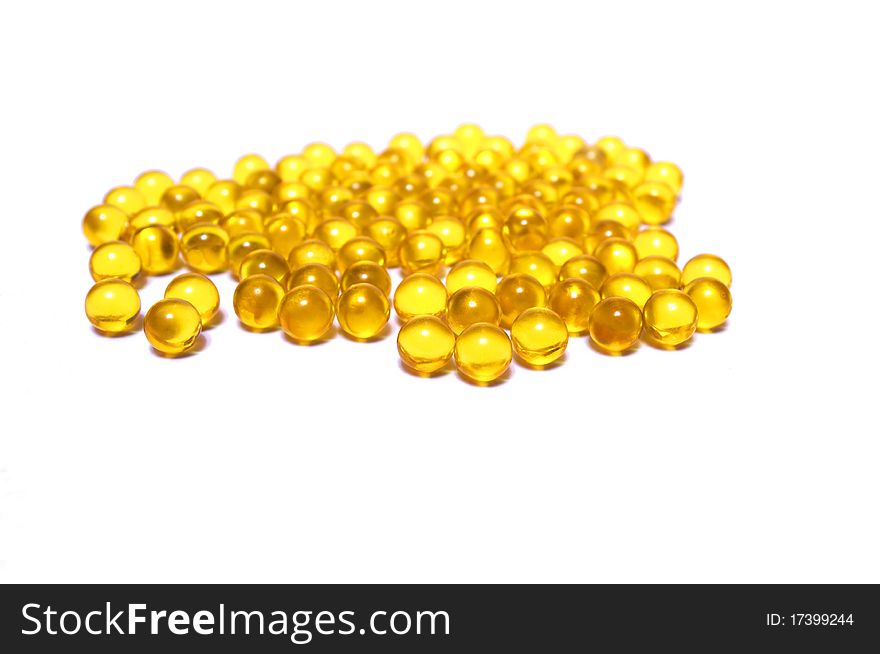 Photo of the yellow capsules on white background