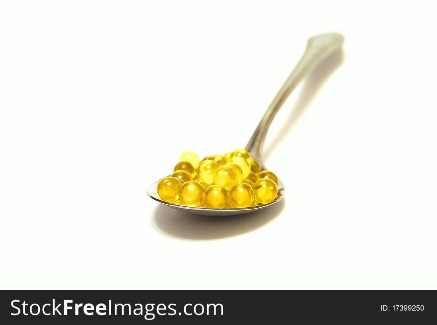 Photo of the yellow capsules on white background