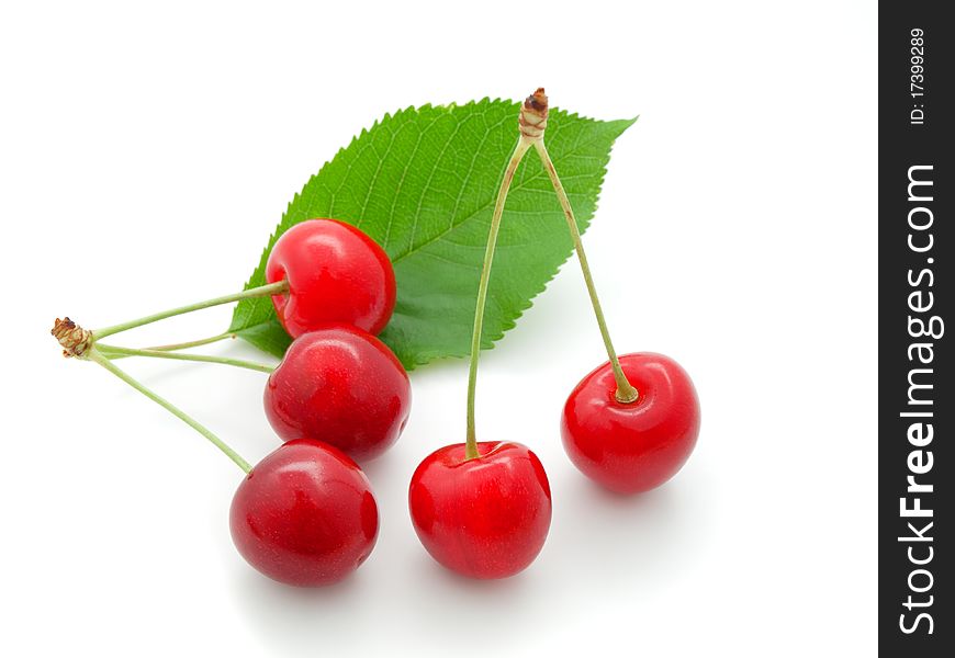 Cherry with a green leaf on white background.