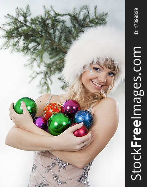 Cheerful girl blond plays with Christmas colorful ball. Cheerful girl blond plays with Christmas colorful ball