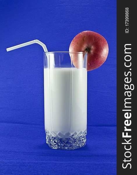 Milk in a glass with a blue background. Milk in a glass with a blue background