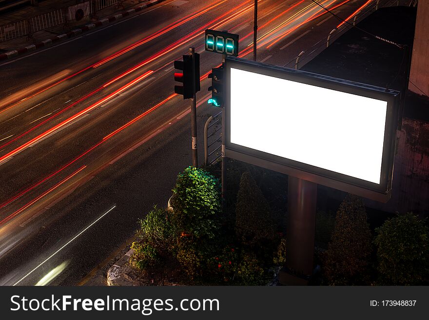 Large billboards on the street at night, with beautiful street lights.