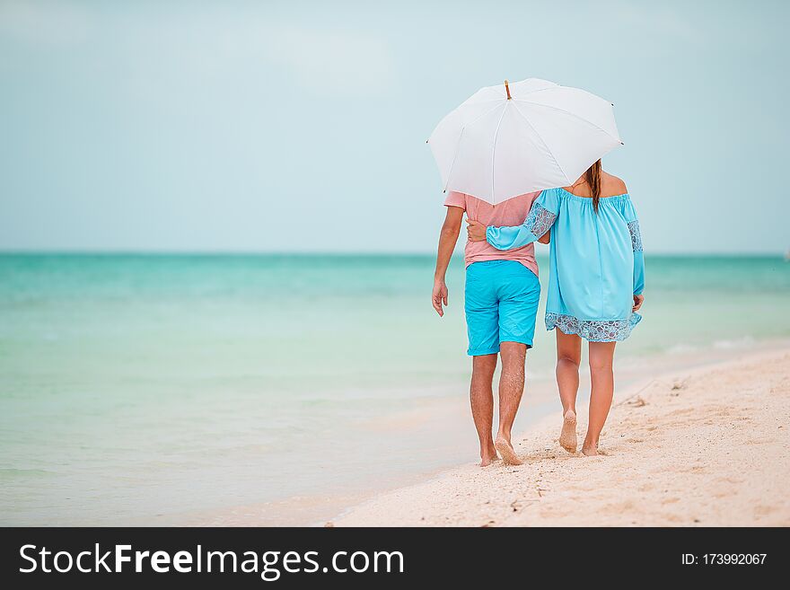 Young Family Of Two On White Beach Have A Lot Of Fun