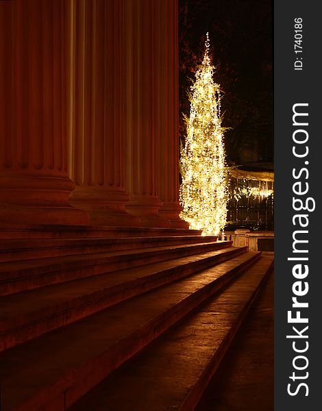 Night scene with Christmas tree in front of an old building columns and stairs. Night scene with Christmas tree in front of an old building columns and stairs