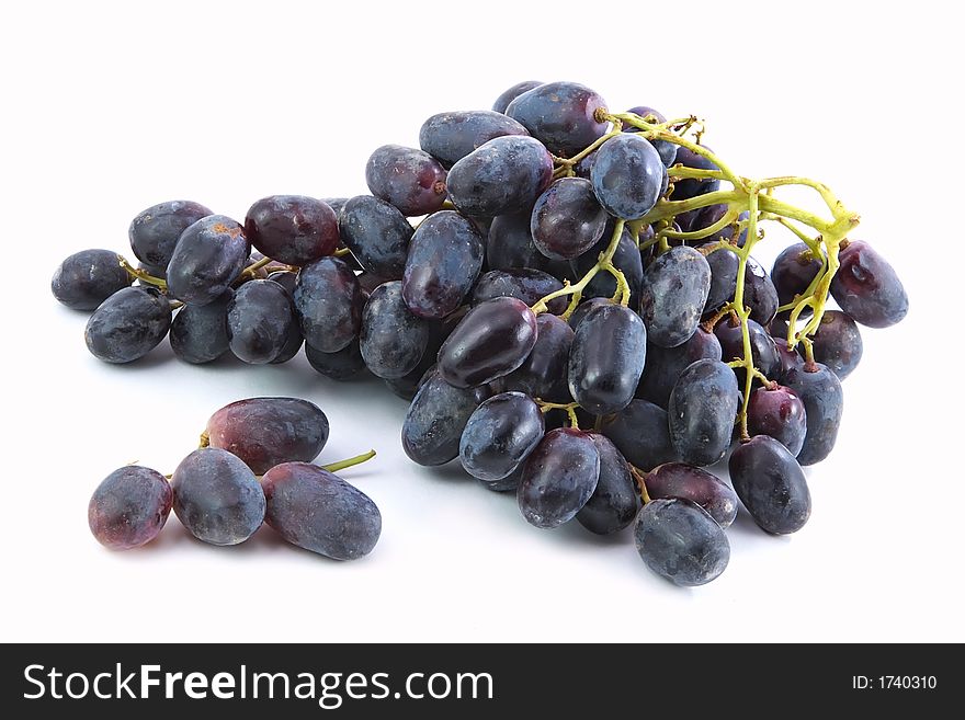 Bunch of red grapes with drops of water on a white background