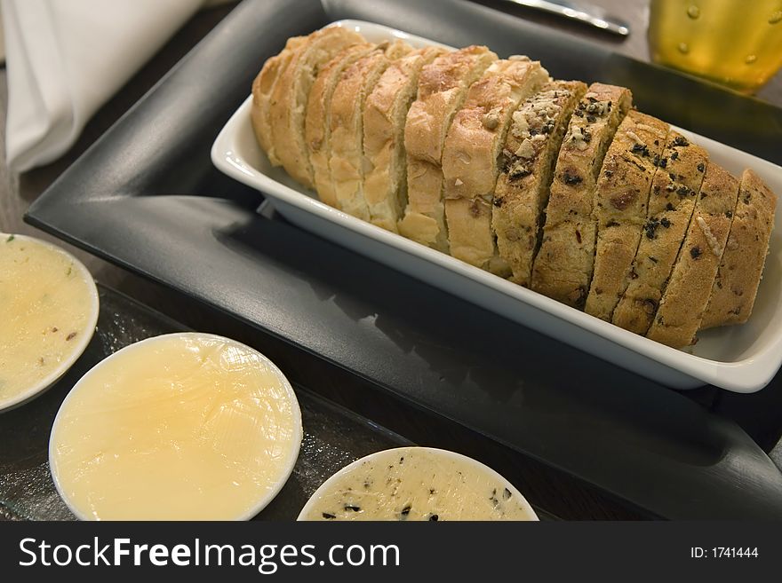 Freshly baked wheat germ bread served with variety of butter