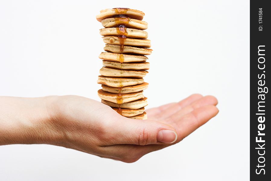 Isolated hand holding a huge stack of pancakes. Isolated hand holding a huge stack of pancakes