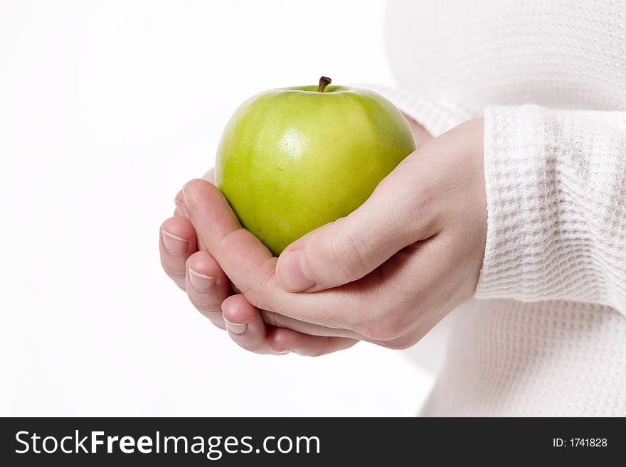 Womans hands holding a grannysmith green apple