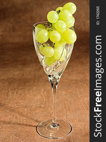 A glass filled with grapes. A glass filled with grapes