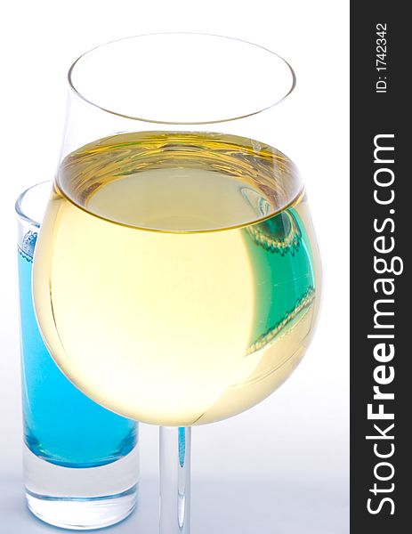 White wine glass and curacao on white background
