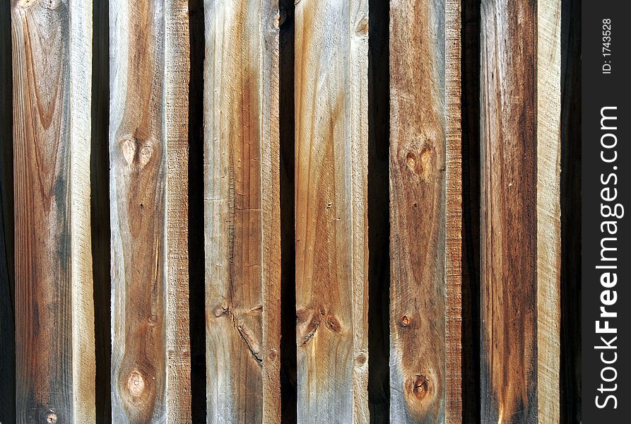 Old Wooden Fence With Weather Marks In Daylight, Background. Old Wooden Fence With Weather Marks In Daylight, Background