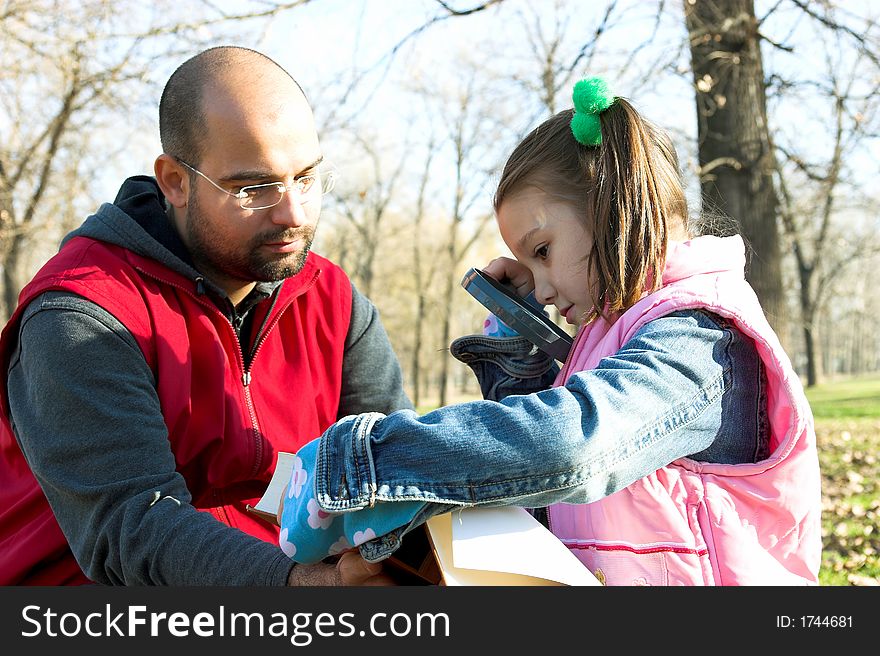 Little pretty child and father reading the book