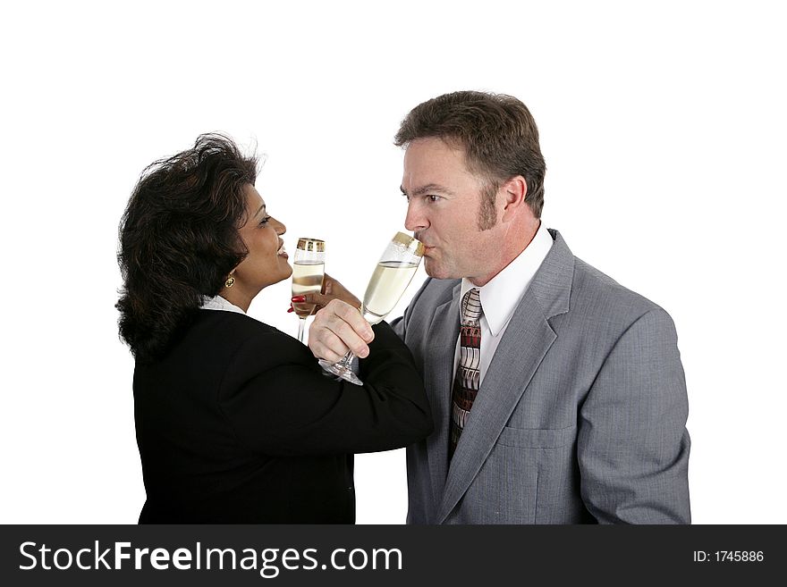 A man and a woman toasting eachother with champagne. Could be either a romantic couple or business partners. A man and a woman toasting eachother with champagne. Could be either a romantic couple or business partners.