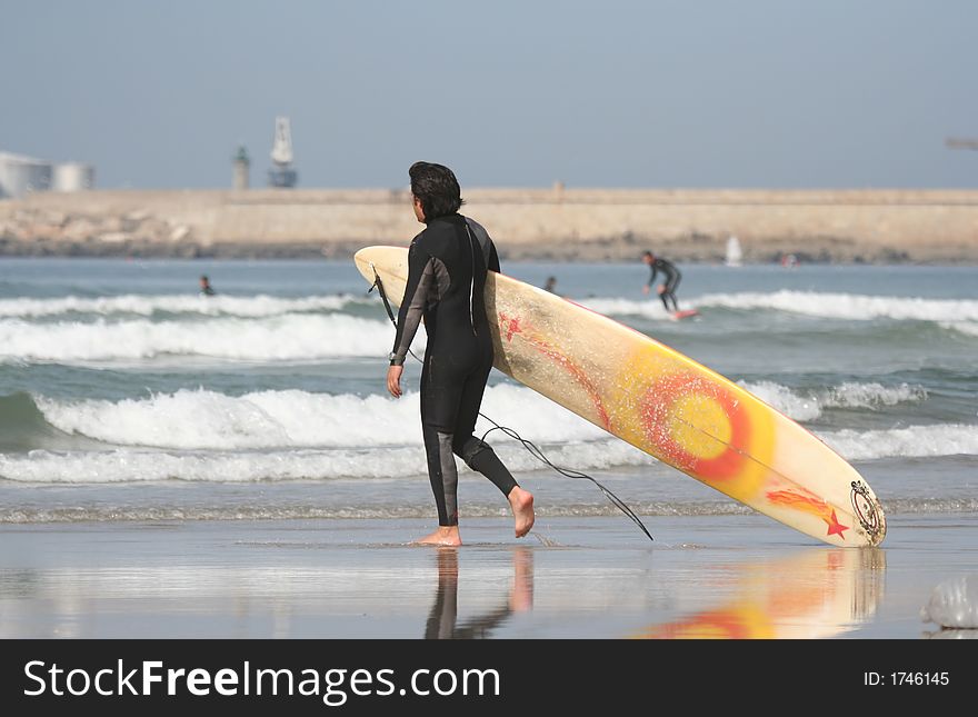 Surfer and board reflex in the beach