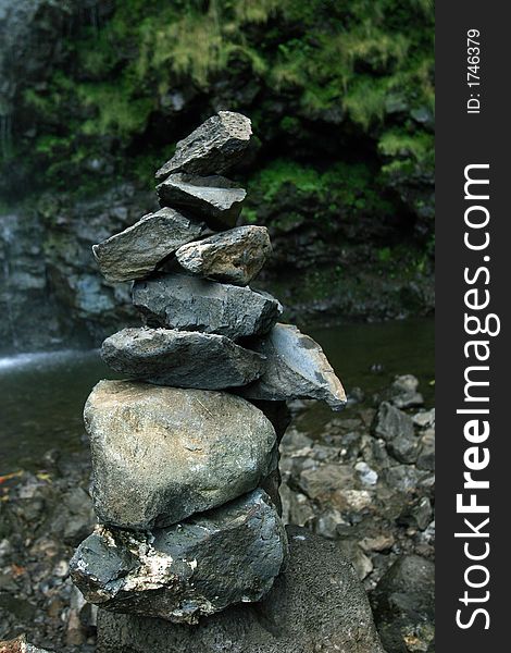 A peaceful stack of rocks under a hawaiian waterfall. A peaceful stack of rocks under a hawaiian waterfall