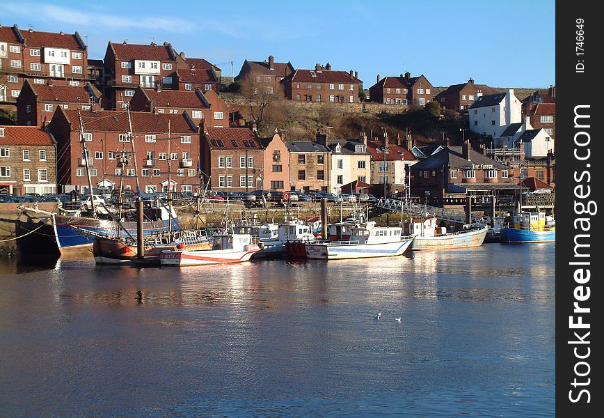 View of Whitby harbour,showing local fishing boats and part of town,on south side of the port