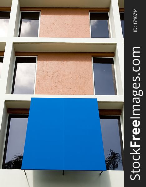 Modern office building tower showing vibrant color blue awning,can be used to lay down type. Modern office building tower showing vibrant color blue awning,can be used to lay down type