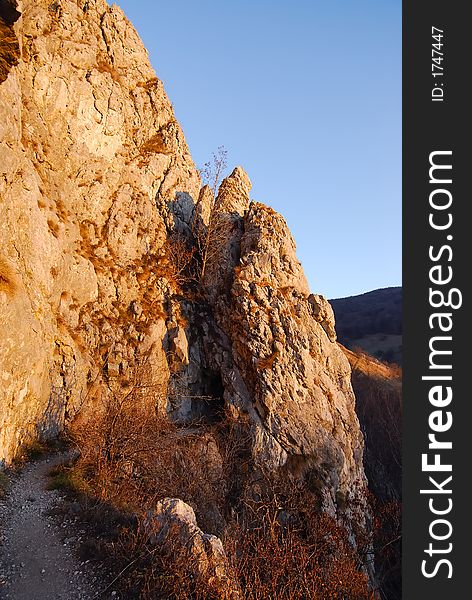 Rocks on a sunny day in the mountains, under sunset light. Rocks on a sunny day in the mountains, under sunset light