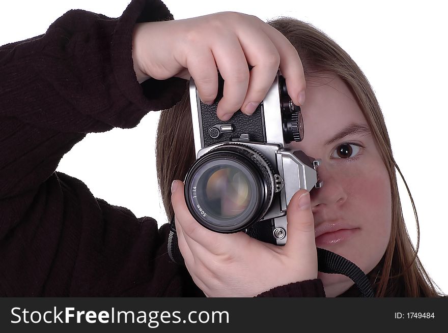 A woman positions a camera for a vertical shot. Half of the woman's face is visible. A woman positions a camera for a vertical shot. Half of the woman's face is visible.