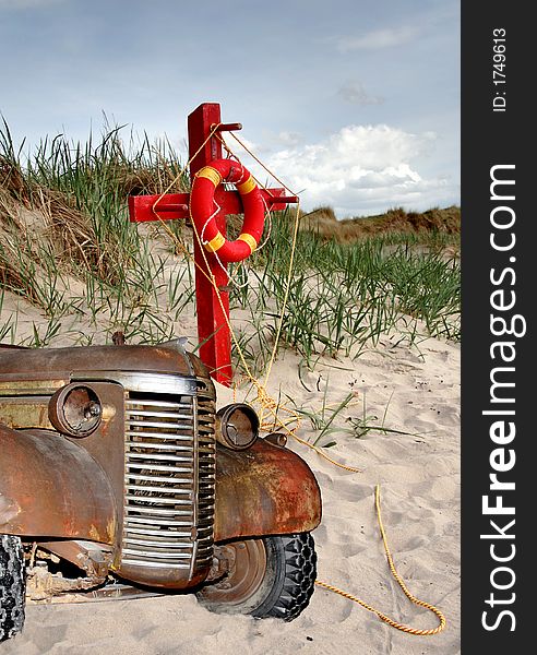 Wrecked Truck and a colourful Lifebelt on a sandy beach. Wrecked Truck and a colourful Lifebelt on a sandy beach