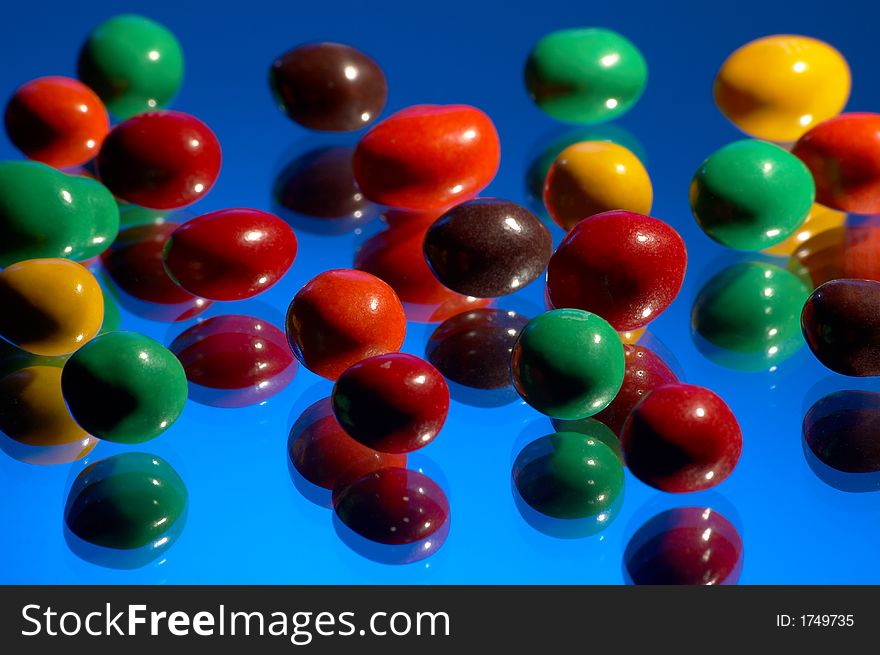 Multi-coloured sweets on a dark blue background