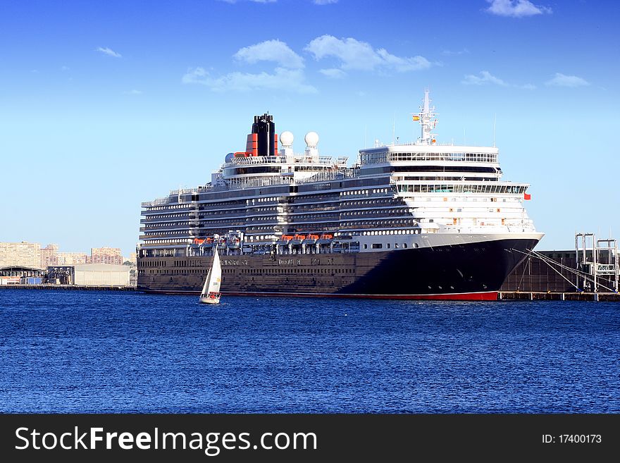 Luxury cruise tied up in Alicante with a sailing boat