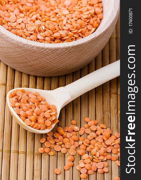 Red lentils in wooden bowl