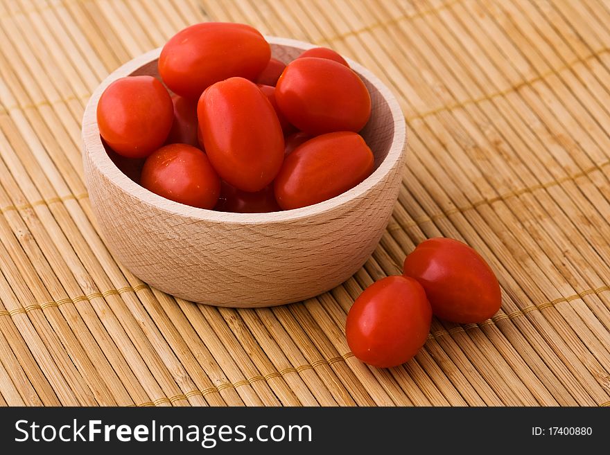 Cherry tomatoes in wooden bowl