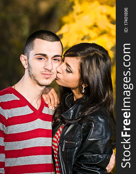 Couple of young lovers are walking in the autumn park. Couple of young lovers are walking in the autumn park