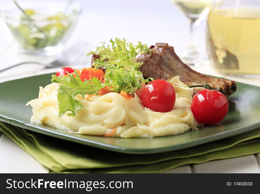 Roasted pork ribs and mashed potato - closeup