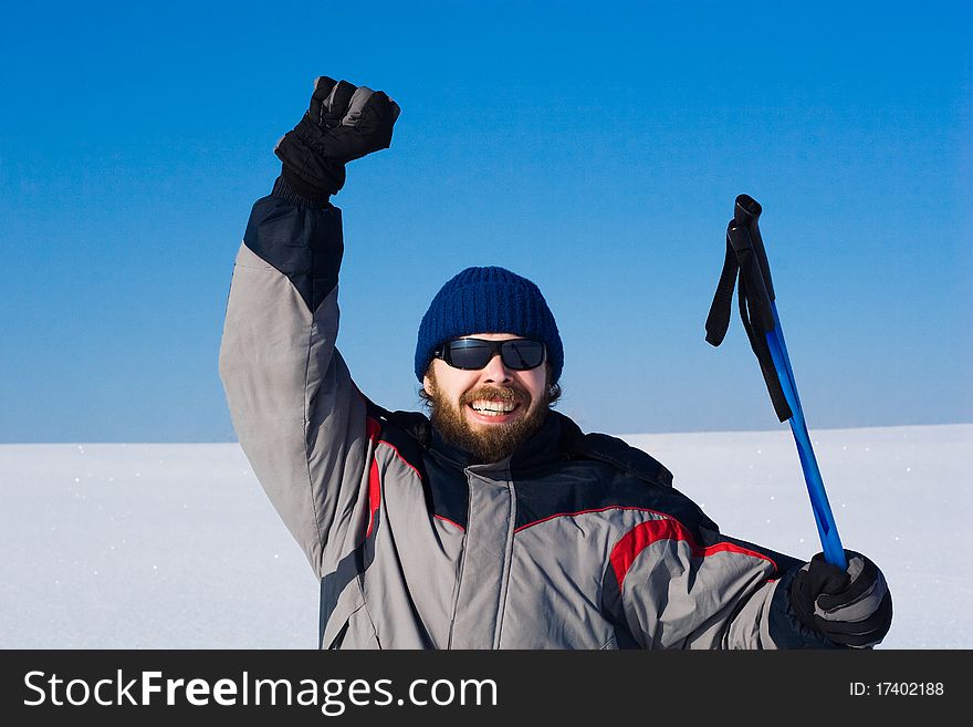 Portrait of handsome skier in the snowy field