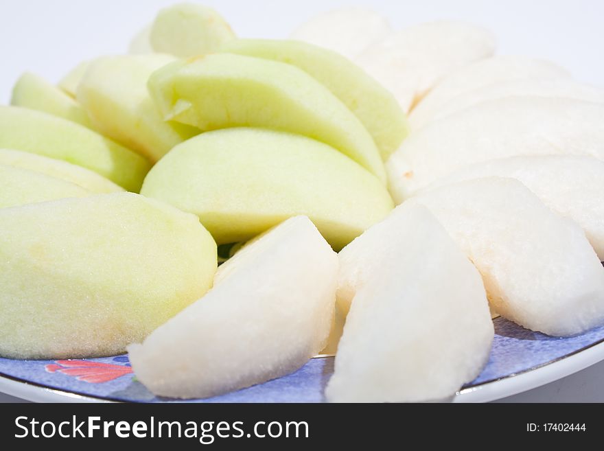 Apples, peeled and wheat. Sort palatable Arranged on the plate insert. On a white background.