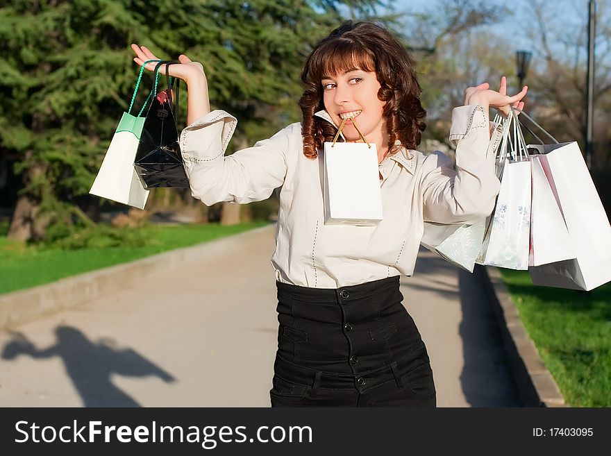 The beautiful young girl with a shopping bags. The beautiful young girl with a shopping bags