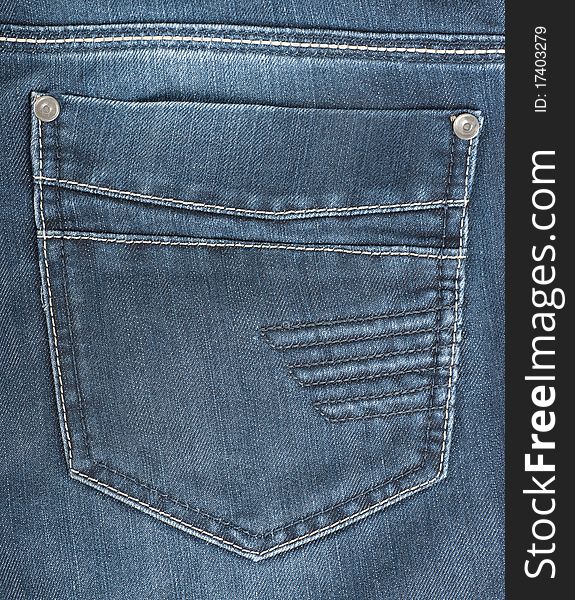 The background of the back pocket of blue jeans. The background of the back pocket of blue jeans