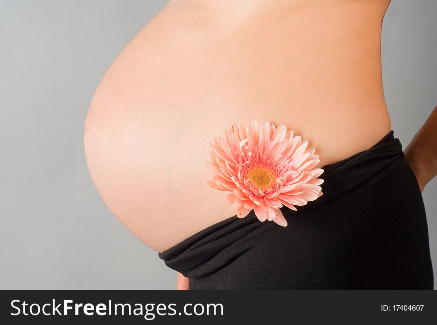 The pregnant woman on 9 month with a flower