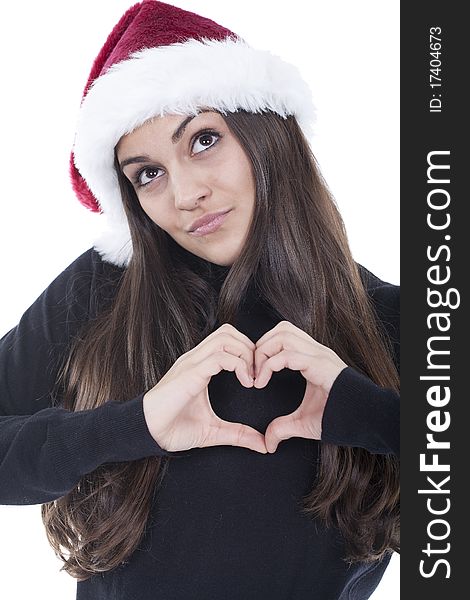 Form of heart shaped by the hands of a young woman with christmas hat